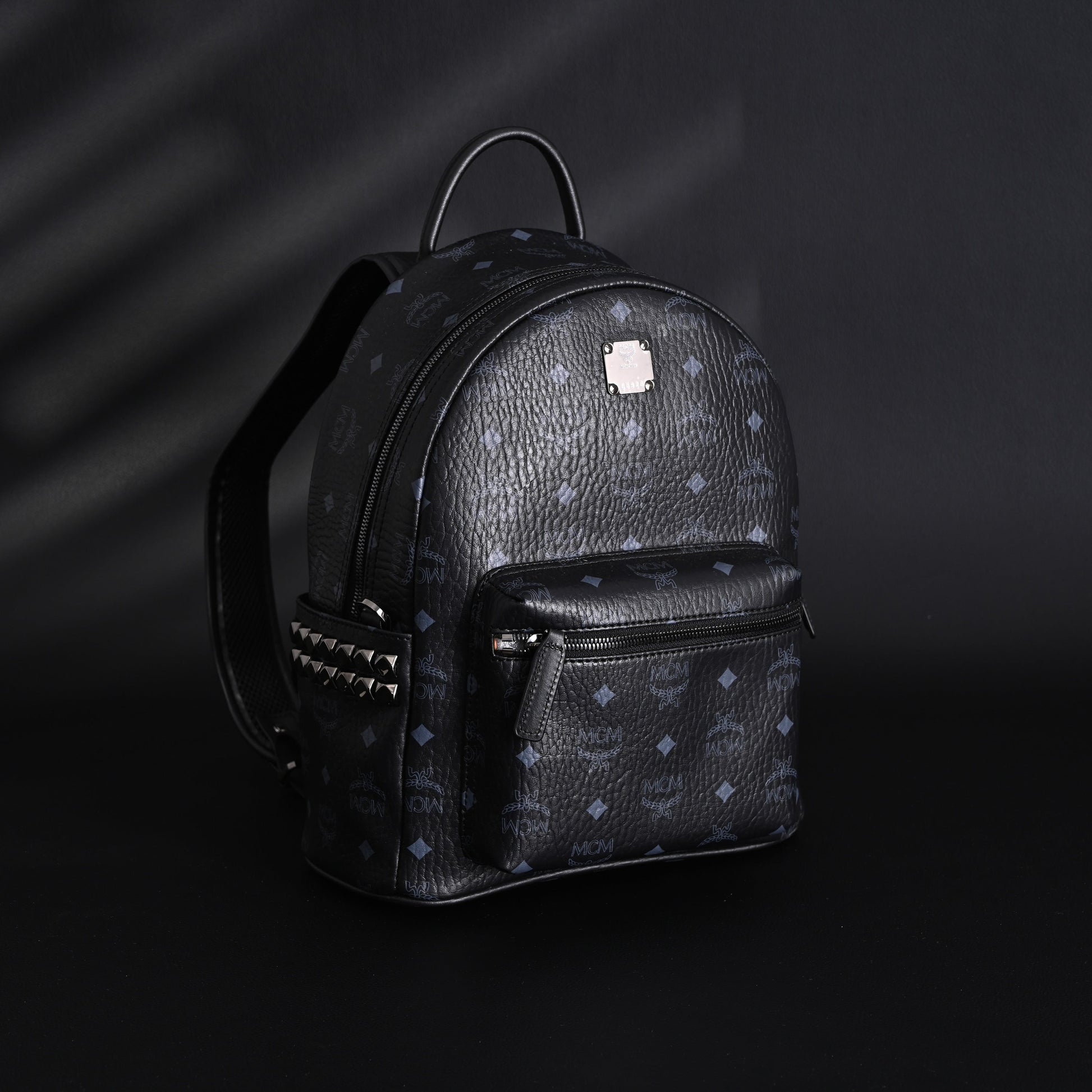 MCM Stark Visetos Medium Backpack – Black Monogram with Studded Detailing