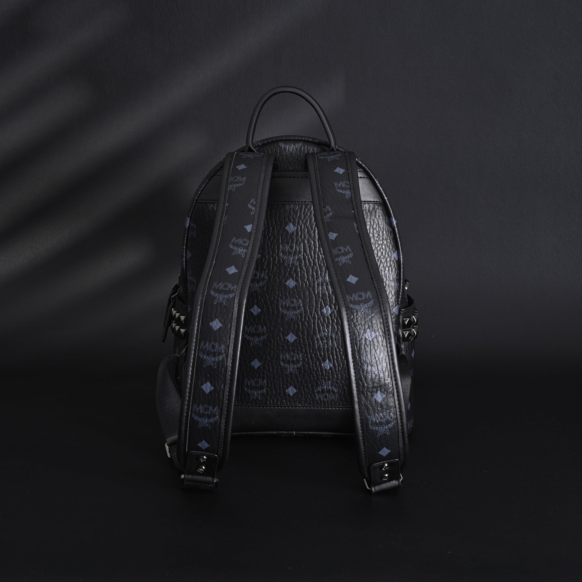 MCM Stark Visetos Medium Backpack – Black Monogram with Studded Detailing