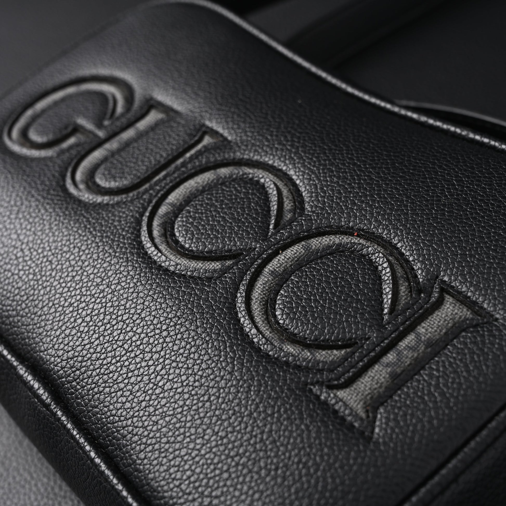 Gucci Black Leather Embossed Logo Belt Bag